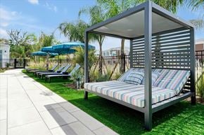 Wildwood apartment for rent - A patio with a couch and a bed.