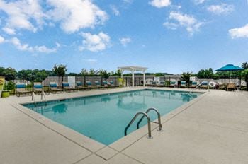 Resort style swimming pool with expansive sundeck at hawthorne at the hall