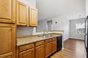Knoxville apartment for rent - A kitchen with wooden cabinets and a granite countertop.
