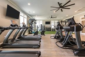 Greensboro apartment for rent - a row of treadmills and televisions in a gym