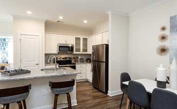 Fuquay-Varina apartment for rent - a kitchen and dining room with stainless steel appliances and a granite counter top