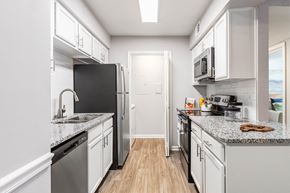 Nashville apartment for rent - a kitchen with white cabinets and stainless steel appliances