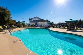 Hope Mills apartment for rent - our apartments have a large swimming pool with chairs and umbrellas
