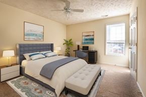 Hope Mills apartment for rent - a bedroom with a bed and a ceiling fan