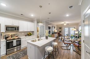 Hope Mills apartment for rent - A modern kitchen with white cabinets and stainless steel appliances.