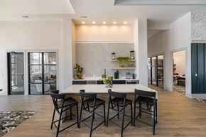 Hope Mills apartment for rent - A modern dining room with a white table and chairs.