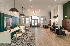 Hope Mills apartment for rent - A modern clubhouse with tall ceilings and many chairs and tables