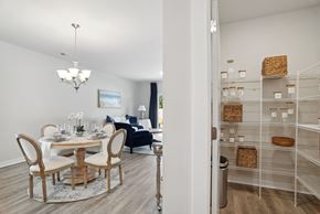 Longs apartment for rent - A dining room with a table and chairs and a pantry at 15 at Heron apartments in Longs, SC.