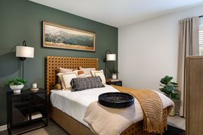 Fayetteville apartment for rent - A bedroom with a bed, nightstands, and a painting on the wall.
