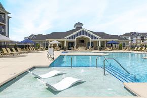 Knoxville apartment for rent - A large swimming pool with a slide and sun loungers.