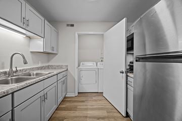 Greenville apartment for rent - A kitchen with a stainless steel refrigerator and white appliances.