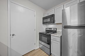 Greenville apartment for rent - Kitchen with a stainless steel refrigerator, oven, and microwave.