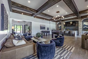 Vestavia Hills apartment for rent - A living room with a brown couch and a chandelier.