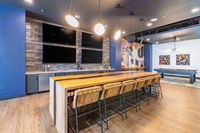 Greensboro apartment for rent - a dining room with a long wooden table and chairs