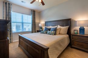 Fayetteville apartment for rent - a bedroom with a large bed and a window