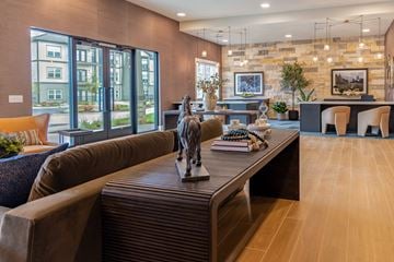 Hendersonville apartment for rent - A living room with a brown couch and a statue on the coffee table.