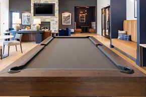 Hendersonville apartment for rent - Close up of a pool table in the middle of a room with a fireplace and a TV behind.