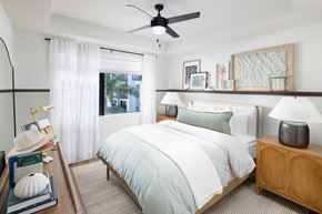 Fort Myers apartment for rent - A bedroom with a large bed and a ceiling fan.