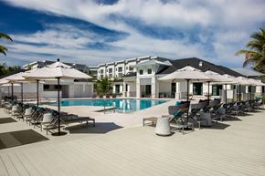 Cape Coral apartment for rent - A poolside area with sun loungers and umbrellas.