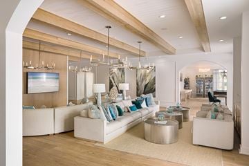 Cape Coral apartment for rent - A modern living room with a white sofa and a wooden ceiling.