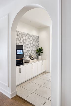 Cape Coral apartment for rent - A kitchen with white cabinets and a tiled backsplash.
