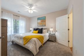 Mcdonough apartment for rent - a bedroom with a bed and a ceiling fan