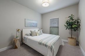 Jacksonville apartment for rent - the preserve at ballantyne commons bedroom with bed and potted plant