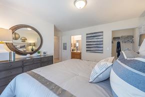 High Point apartment for rent - a bedroom with a bed and a mirror and a closet