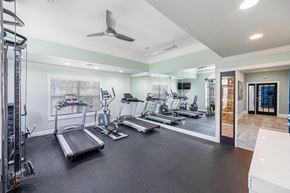 Greensboro apartment for rent - a gym with cardio machines and a ceiling fan