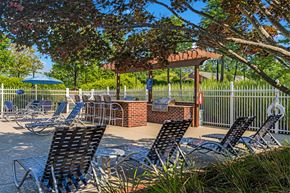 High Point apartment for rent - a patio with chairs and tables and a gazebo
