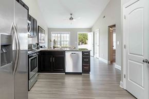 Greenville townhouse for rent - A modern kitchen with a large refrigerator and a dishwasher.