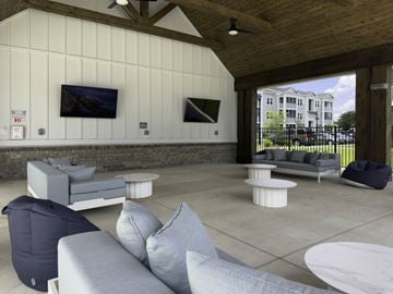 Myrtle Beach apartment for rent - A modern living room with a grey sofa and a white coffee table.