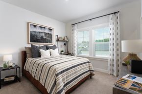 Wilmington townhouse for rent - A bedroom with a large bed and a painting on the wall.