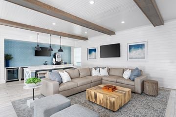 Wilmington townhouse for rent - A modern living room with a grey sofa and a wooden coffee table.
