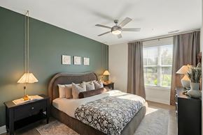 Candler apartment for rent - A bedroom with a large bed and a ceiling fan.