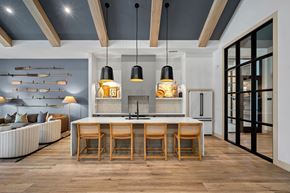 Candler apartment for rent - A modern kitchen with a wooden table and chairs.