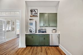 Greensboro apartment for rent - A kitchen with green cabinets and a white fridge.