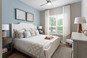 Wilmington apartment for rent - A bedroom with a large bed and a ceiling fan.