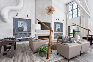 Wilmington apartment for rent - A living room with a fireplace and a painting of a bird on the wall.
