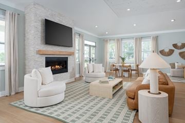 Leland apartment for rent - A living room with a fireplace and a television above it.