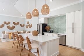 Leland apartment for rent - A kitchen with a white counter and wooden chairs.
