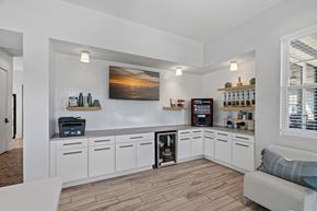 Cary apartment for rent - A kitchen with white cabinets and a wooden floor.