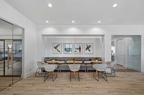 Cary apartment for rent - A modern dining room with a glass table and chairs.