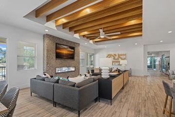 Cary apartment for rent - A modern living room with a grey sofa and a wooden ceiling.