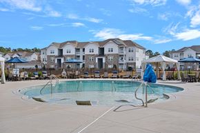 Hampstead apartment for rent - A swimming pool in front of apartment buildings.