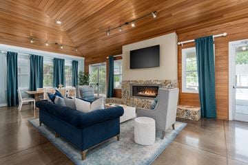 Wilmington apartment for rent - A living room with a blue couch and a fireplace.