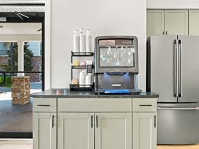 Ooltewah apartment for rent - A kitchen with a refrigerator, a microwave, and a counter with a stone pillar.