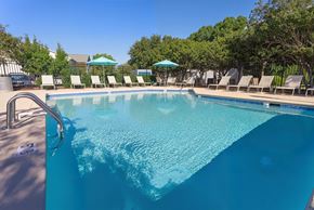 Wilmington apartment for rent - A large swimming pool with a metal ladder and a white sign on the side.