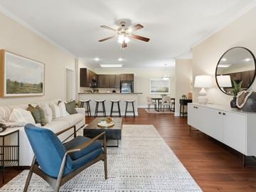 Warner Robins apartment for rent - A living room with a blue chair and a white couch.