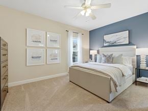 Warner Robins apartment for rent - A bedroom with a large bed and a ceiling fan.